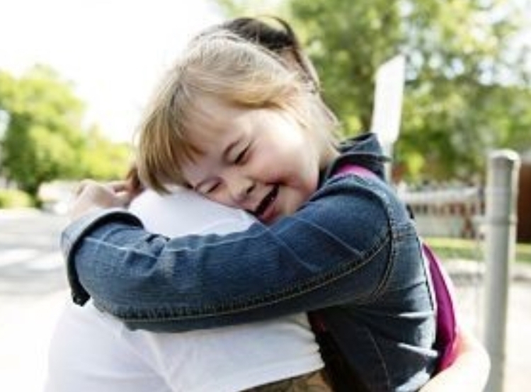 young special needs girl hugging mother